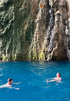 Two people, swiming inside Haxhi Ali Cave