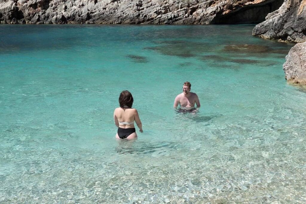 two people enjoying the crystal clear waters of Grama Bay